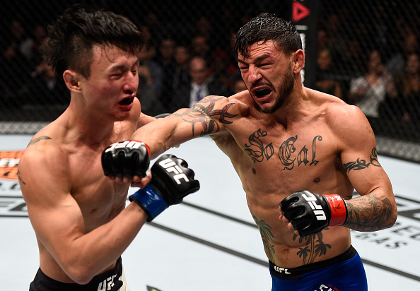 TORONTO, CANADA - DECEMBER 10: (R-L) Cub Swanson punches Dooho Choi of South Korea in their featherweight bout during the UFC 206 event inside the Air Canada Centre on December 10, 2016 in Toronto, Ontario, Canada. (Photo by Jeff Bottari/Zuffa LLC/Zuffa LLC via Getty Images)